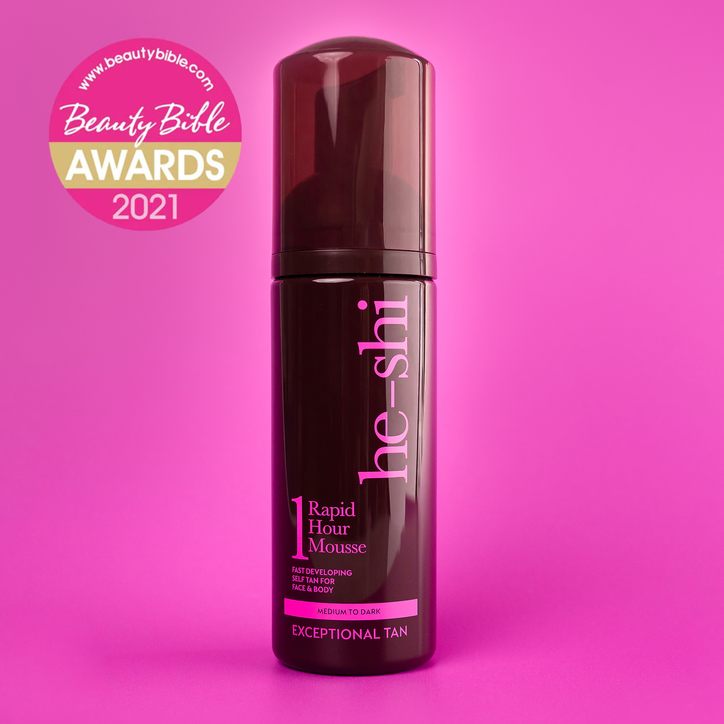 He-Shi Rapid 1 Hour Tanning Mousse bottle on pink background featuring a Beauty Bible Awards 2021 Logo