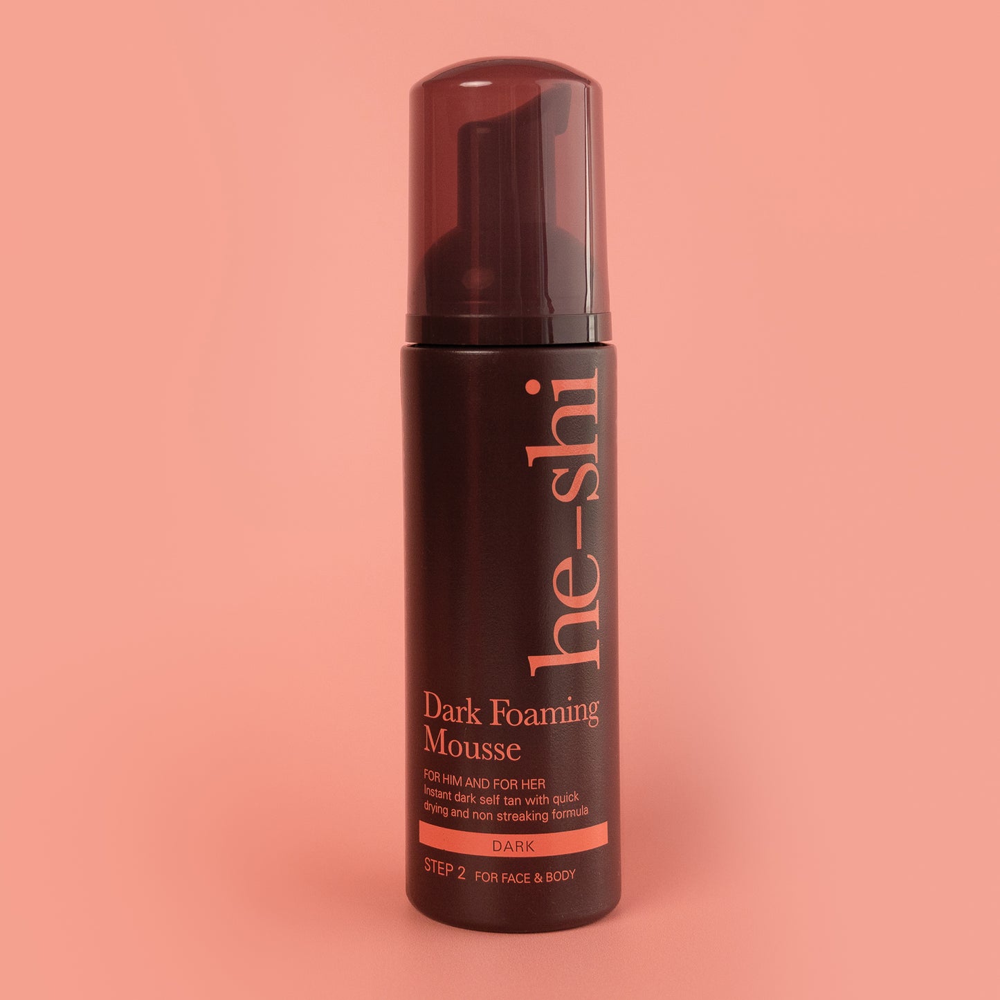 Image of Dark Foaming Mousse bottle on peach background
