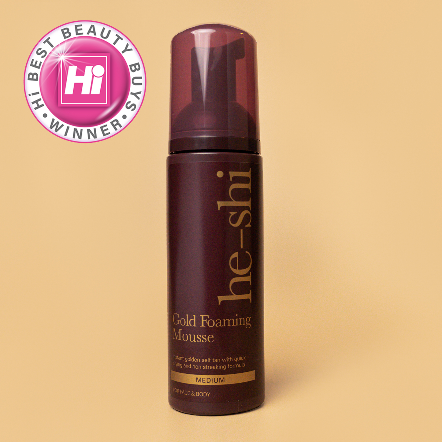 Image of He-Shi Gold Foaming Mousse bottle on a pale gold background. The image also features a Hi Style Best Beauty Buys Winner icon