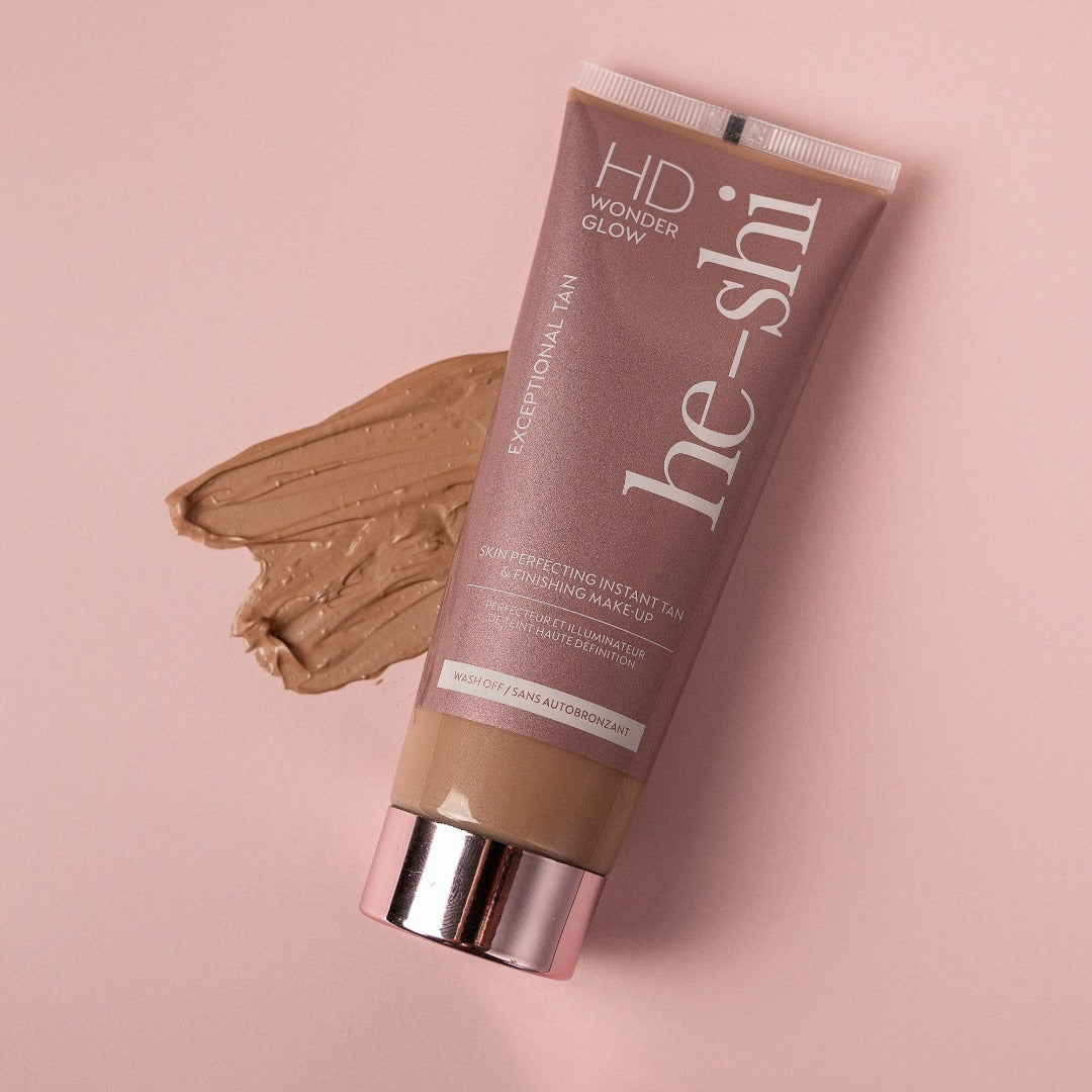 Image of HD Wonderglow body tint tube lying on its side with a cream texture of the product beside it