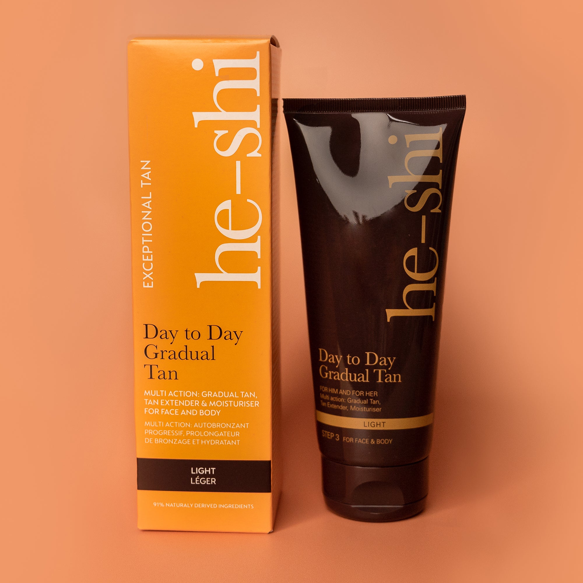 Image of He-shi Light Day to Day Gradual Tan tube and outer box on a peach background