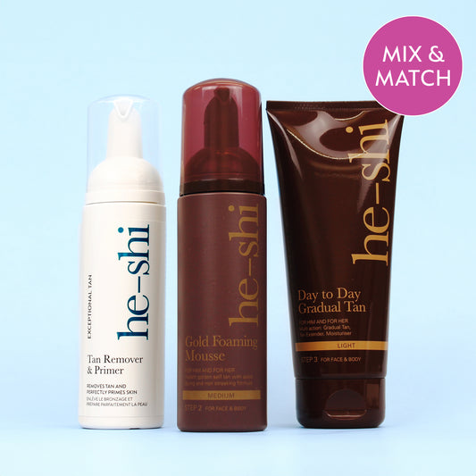 Image of He-Shi Tan Remover & Primer, Gold Foaming Mousse and Day to Day Gradual Tan bottles in a row on a light blue background. The image features a purple roundel in the top right corner which says "Mix & Match"