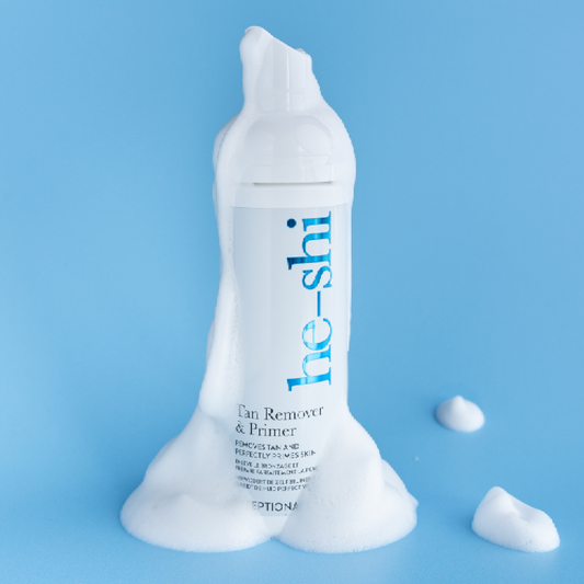 Image of He-Shi Tan Remover & Primer on blue background with the white foam product dripping down the bottle.
