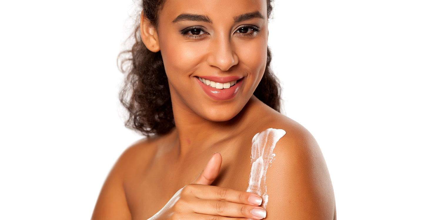 woman applying lotion to skin