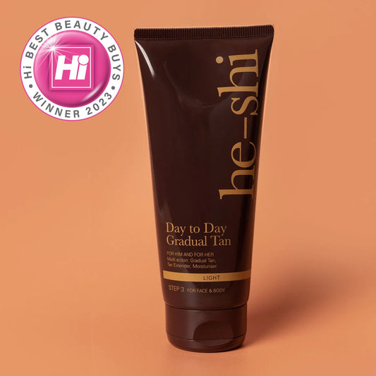 He-shi day to day gradual tan medium tube shown on a peach background and hi best beauty buys winner 2023 logo displayed in corner