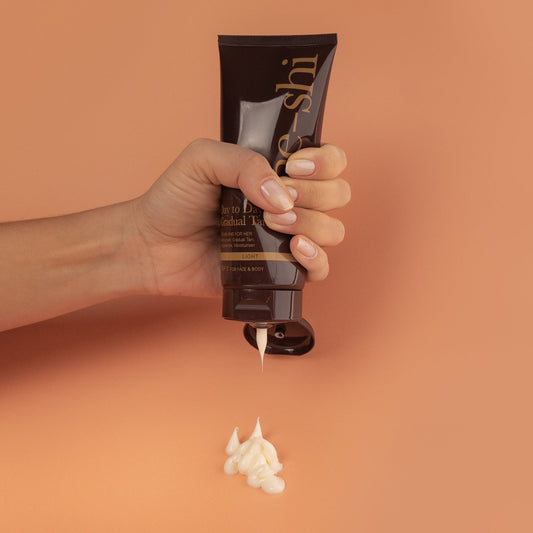 Image of the Gradual Tan being squeezed, showing a rich creamy white formula